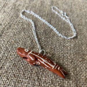 Emma Carlow Tiny clay whistle on a fabric background - Fish