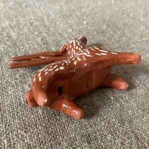 Emma Carlow pottery whistle in the shape of a reindeer against a cloth backdrop