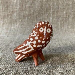 Emma Carlow Pottery whistle in shape of an owl on a fabric background