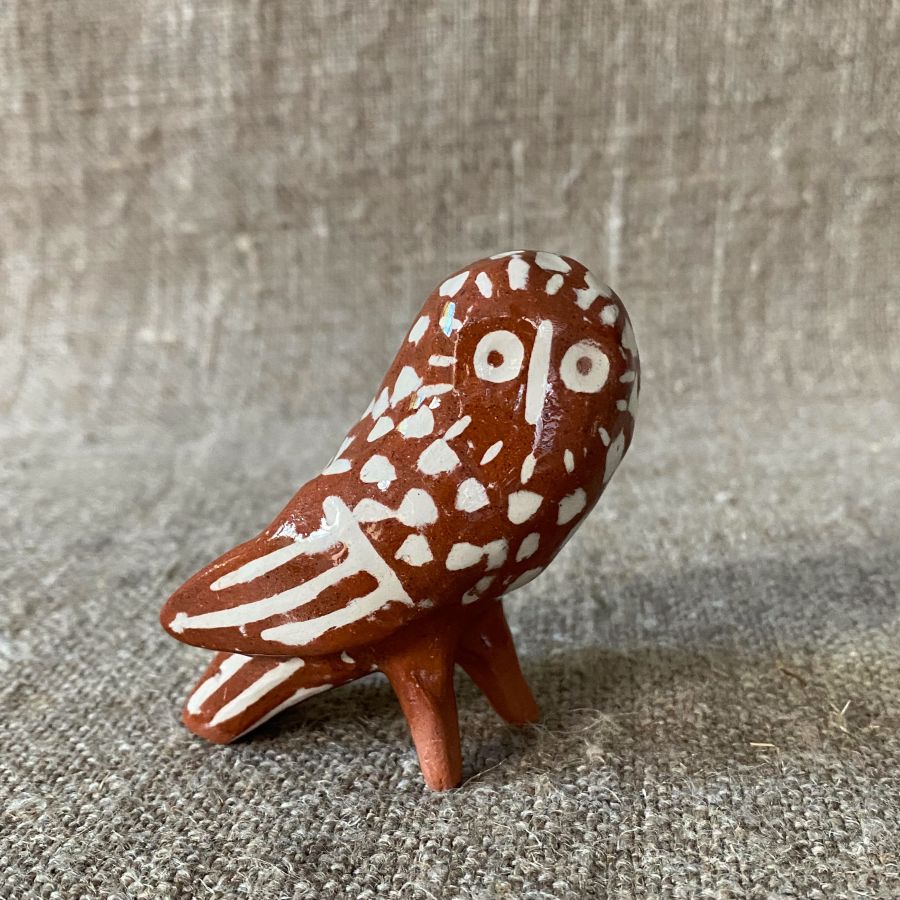 Emma Carlow Pottery whistle in shape of an owl on a fabric background