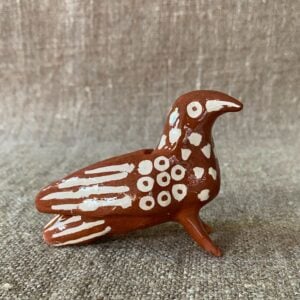Emma Carlow Pottery whistle in shape of a Bird on a fabric background