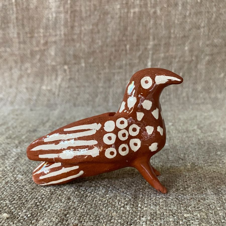 Emma Carlow Pottery whistle in shape of a Bird on a fabric background