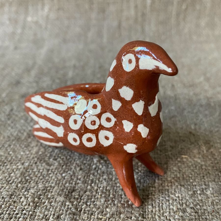 Emma Carlow Pottery whistle in shape of a Bird on a fabric background