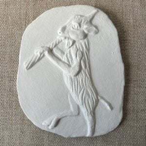 Pargetted lime plaster relief featuring goat with a pipe