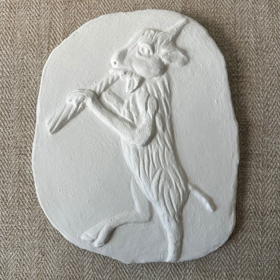 Pargetted lime plaster relief featuring goat with a pipe