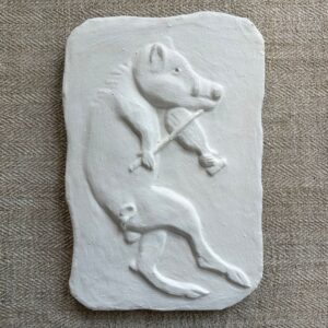 Pargetted lime plaster relief featuring boar with a fiddle