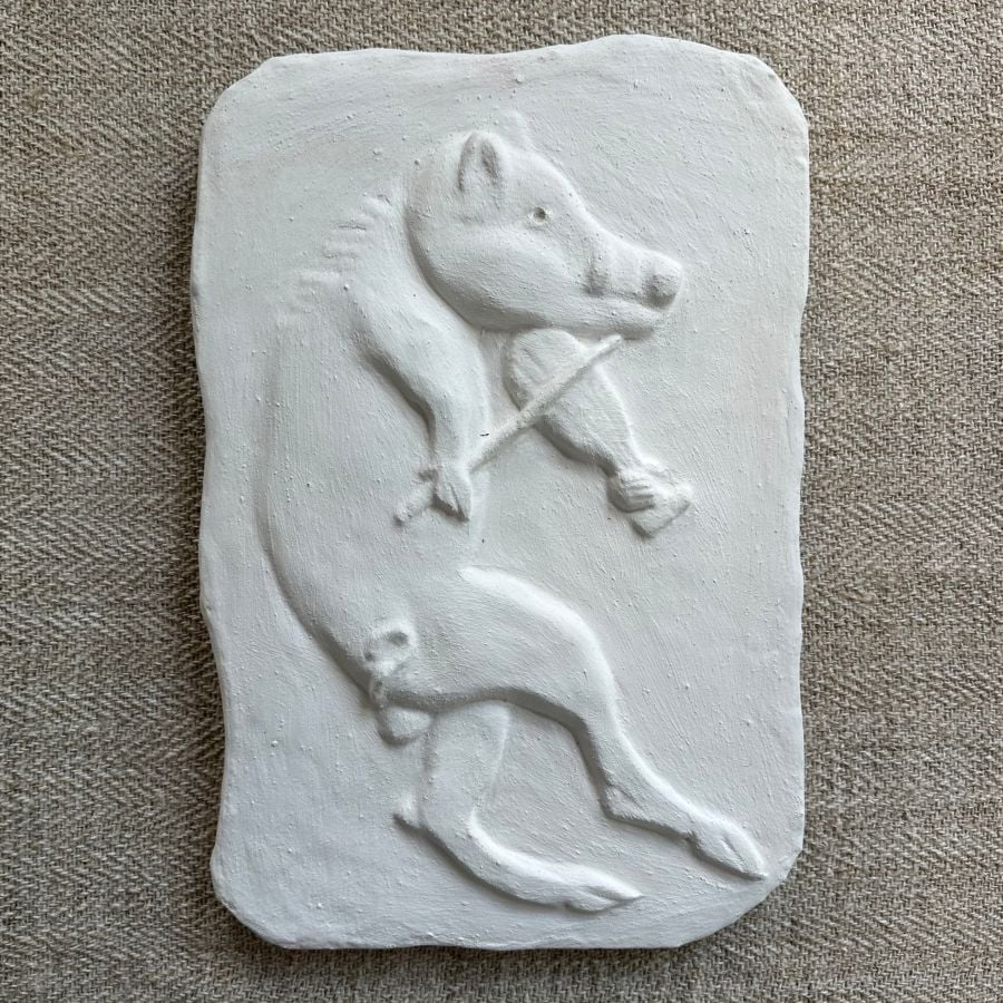 Pargetted lime plaster relief featuring boar with a fiddle