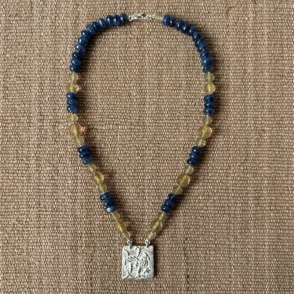 Silver Hawk necklace with blue and amber beads