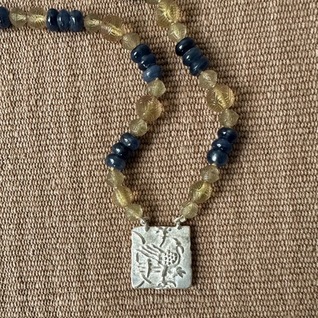 Silver Hawk necklace with blue and amber beads