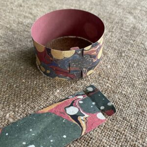 Marbled paper chains on a cloth background