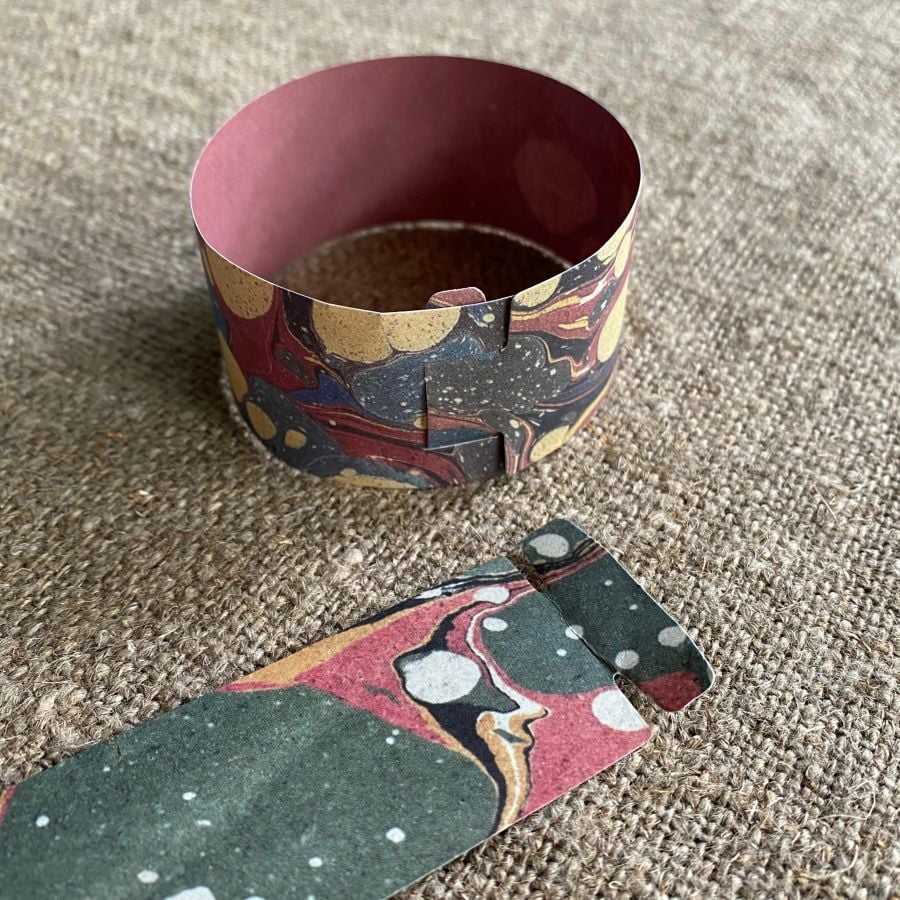 Marbled paper chains on a cloth background