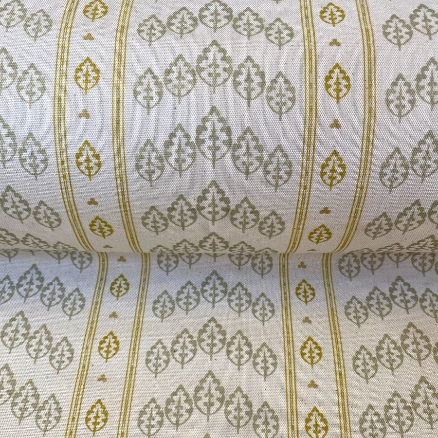 Striped pattern fabric on a slant with a repeated tree design in flax and yellow