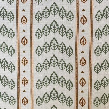 Striped pattern fabric on a slant with a repeated tree design in green & brown
