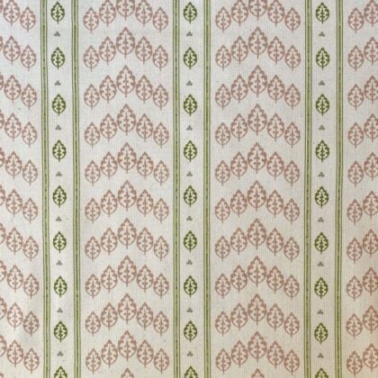 Detail of a roll of striped fabric with a tree motif, in pink, green & ivory