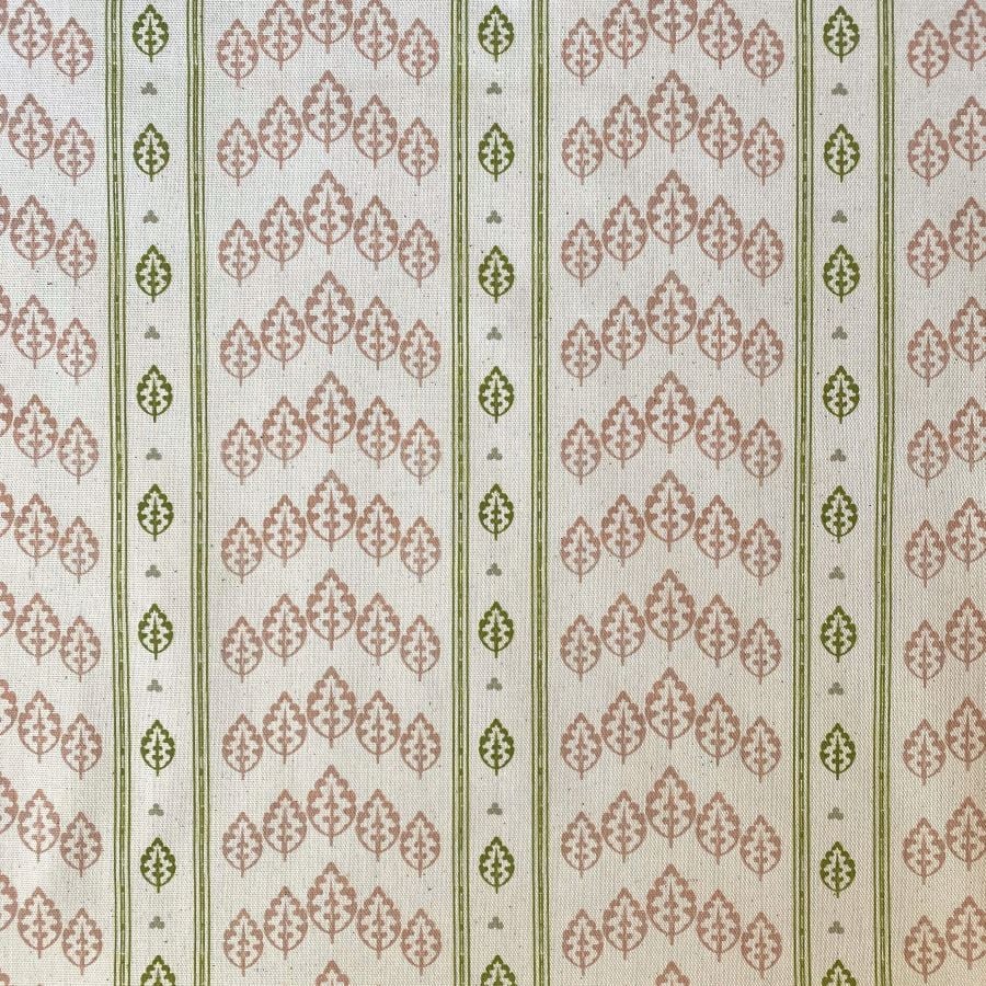 Detail of a roll of striped fabric with a tree motif, in pink, green & ivory