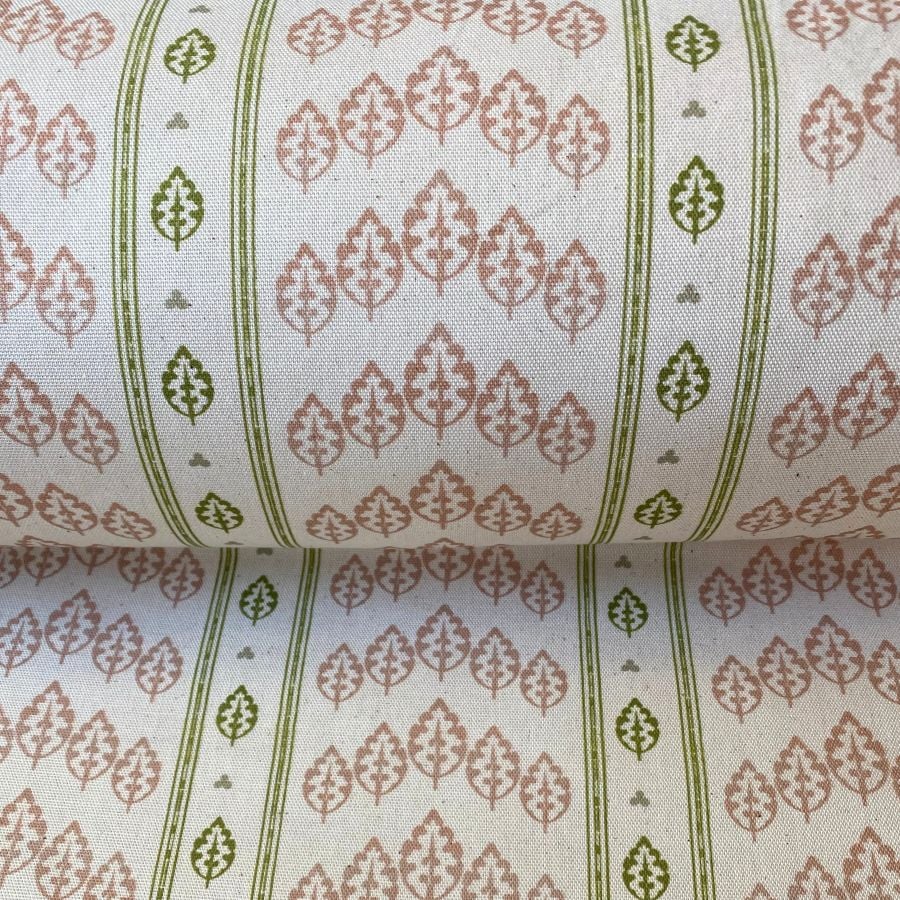 Detail of a roll of striped fabric with a tree motif, in pink, green & ivory