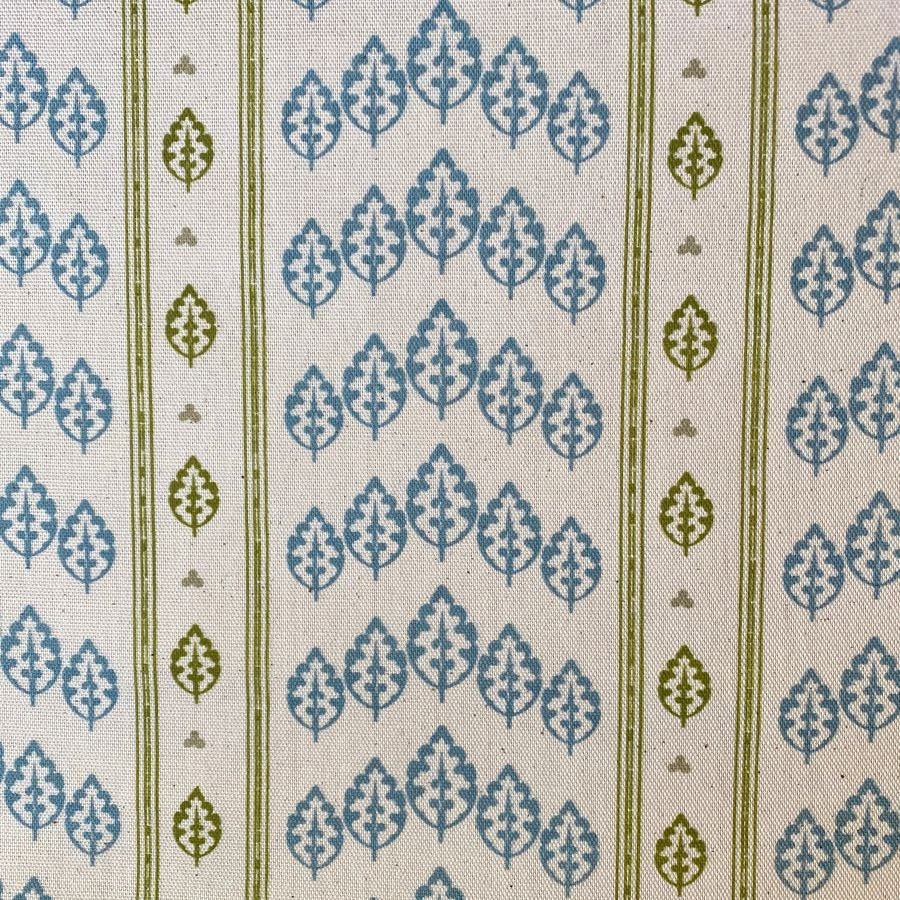 Striped pattern fabric with a repeated tree design in blue and olive green