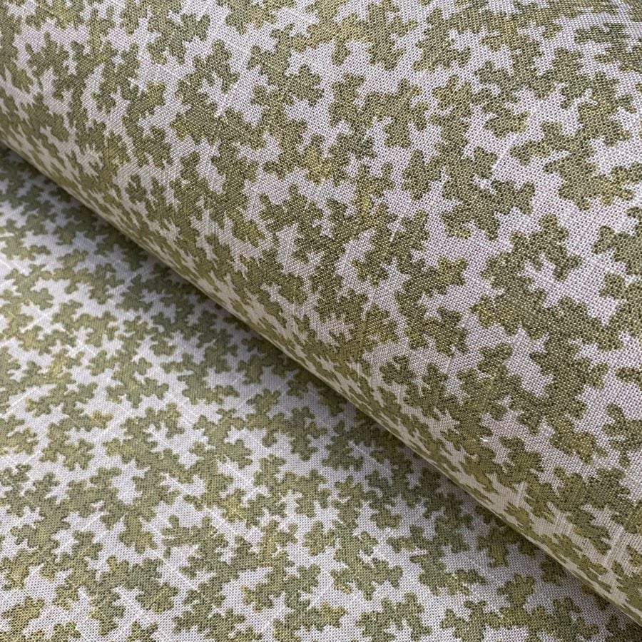 Slanted roll of fabric featuring a small scale coral design in olive green