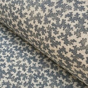 Diagonal roll of a small scale patterned fabric with a blue print
