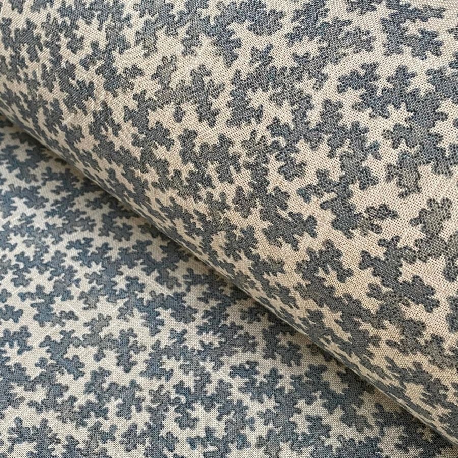 Diagonal roll of a small scale patterned fabric with a blue print