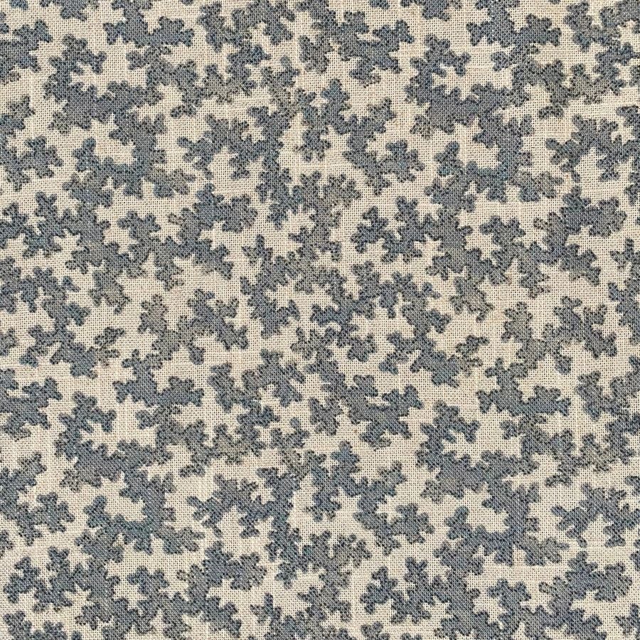 A small scale patterned fabric with a blue sinuous print