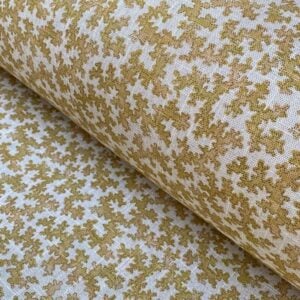 Slanted roll of fabric featuring a small scale coral design in mustard yellow