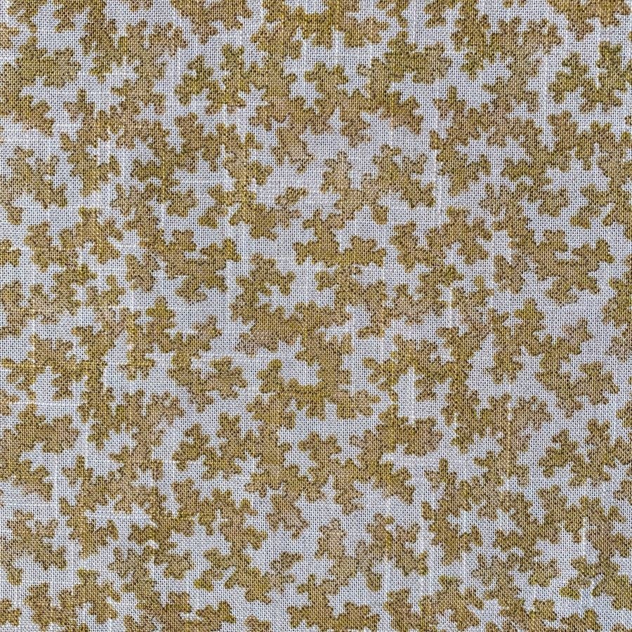 Fabric featuring a small scale coral design in mustard yellow