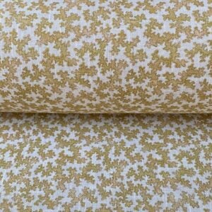 Slanted roll of fabric featuring a small scale coral design in mustard yellow