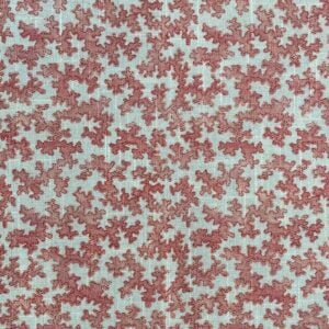 Slanted roll of fabric featuring a small scale coral design in pinkish red
