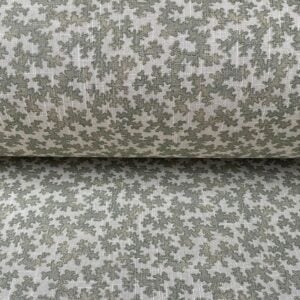 Detail of a small scale fabric design on a roll