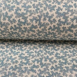 Slanted roll of fabric featuring a small scale coral design in light blue