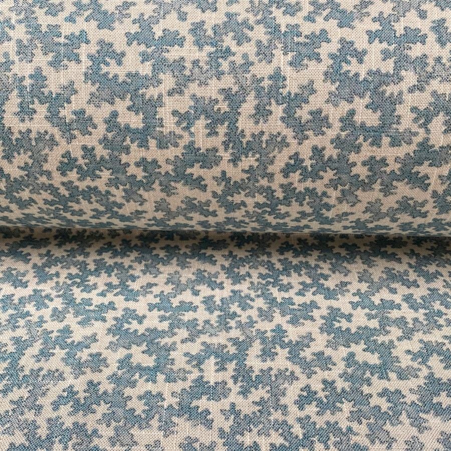Slanted roll of fabric featuring a small scale coral design in light blue