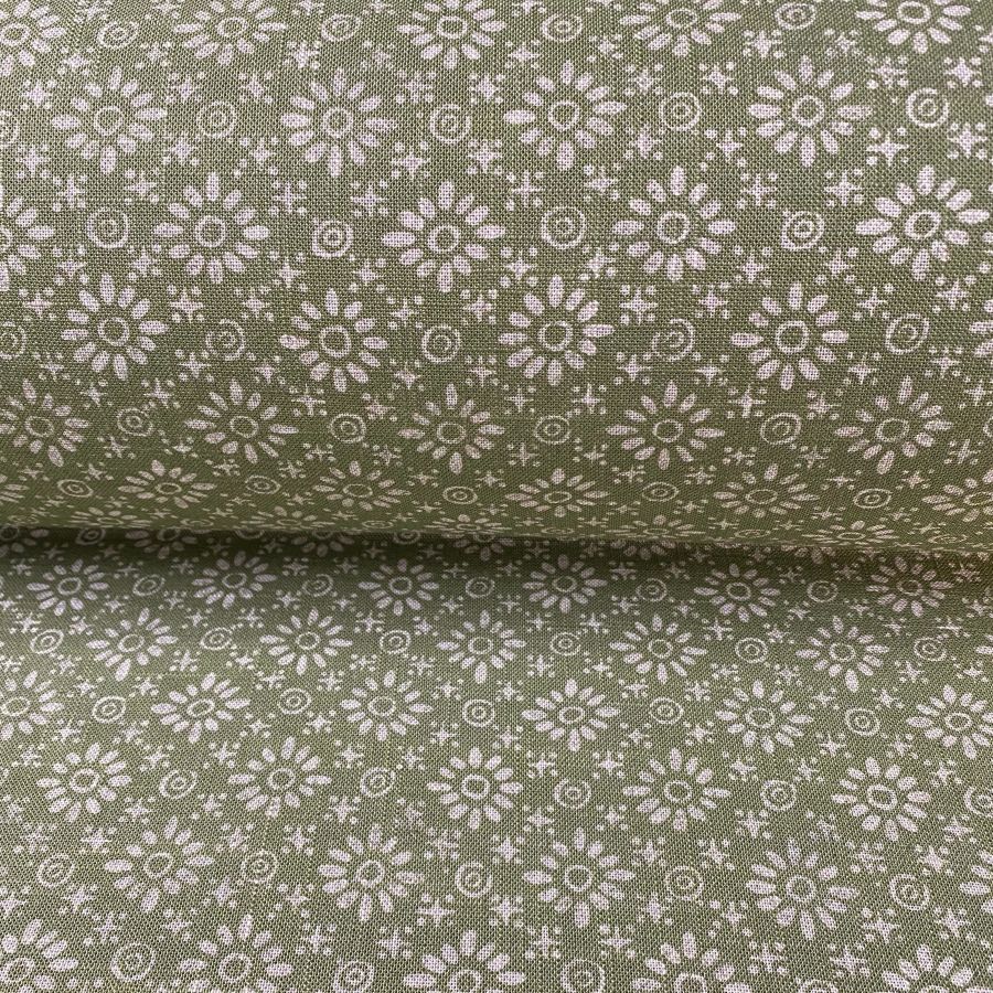 Fabric roll with green, small scale daisy pattern