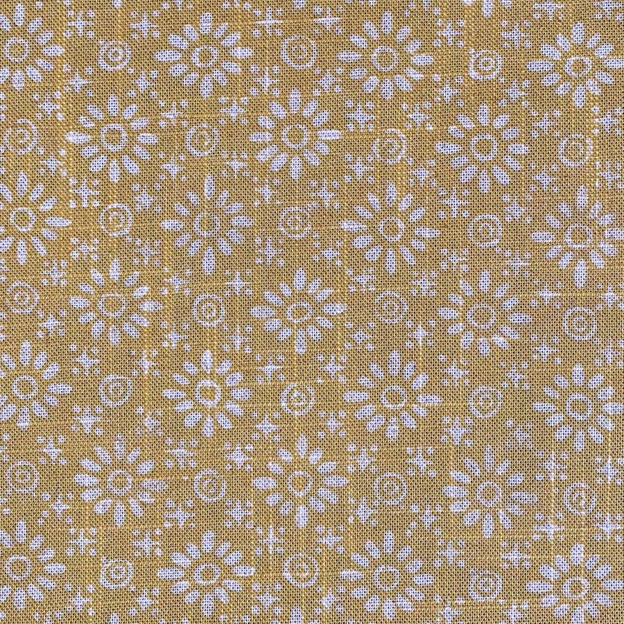 Fabric roll with mustard yellow, small scale daisy pattern