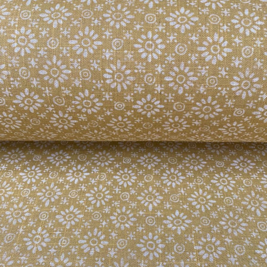 Fabric roll with mustard yellow, small scale daisy pattern