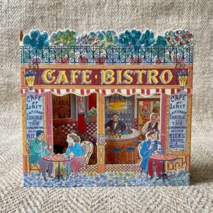 3d stand up card of a cafe bistro shop against a pale fabric background