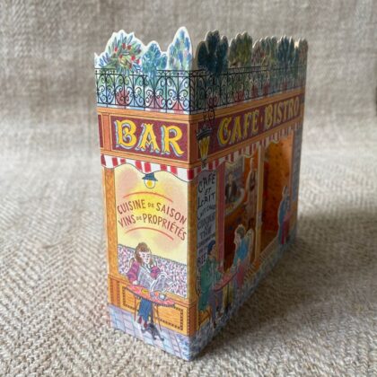 3d stand up card of a cafe bistro shop against a pale fabric background