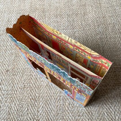 3d stand up card of a cafe bistro shop against a pale fabric background