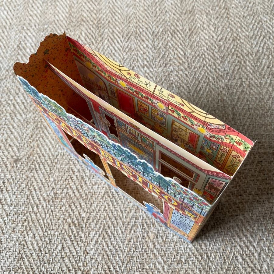 3d stand up card of a cafe bistro shop against a pale fabric background