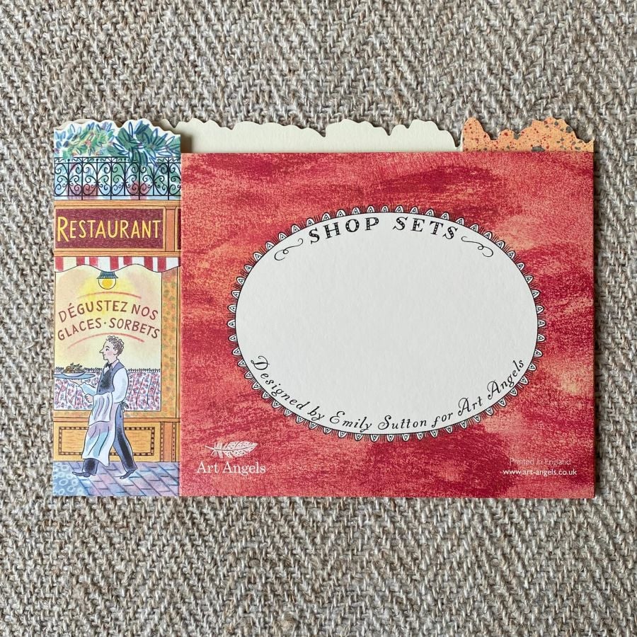 3d stand up card of a cafe bistro shop against a pale fabric background